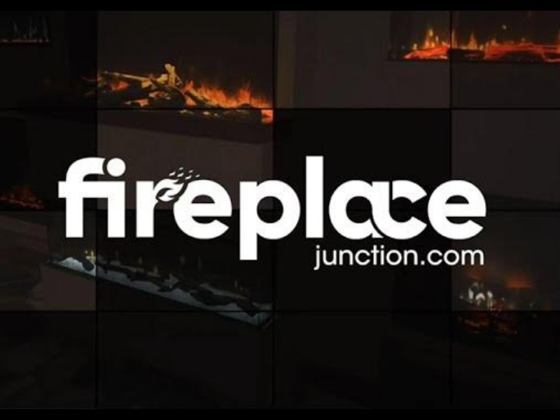 Modern electric fireplace display with glowing flames and logs, featuring the logo of Fireplace Junction.